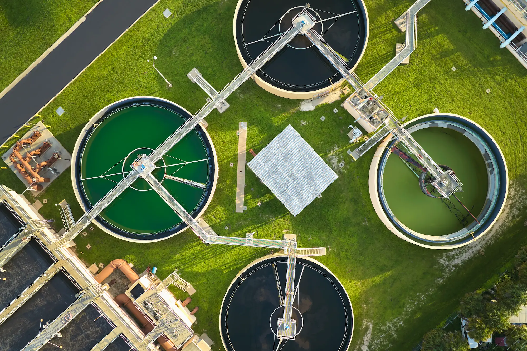 Arial view of waste water treatment tanks surrounded by green grass