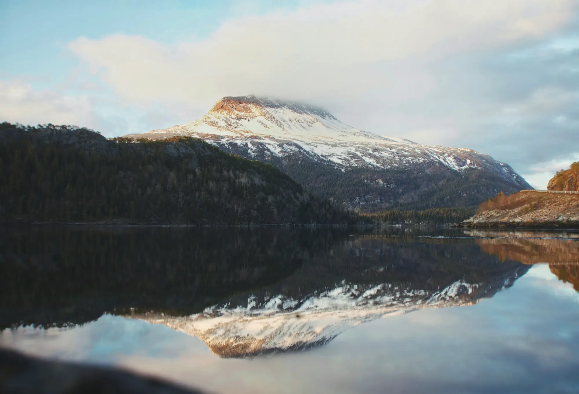 View of a snow-capped mountain with a lake in front of it